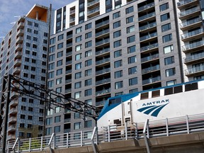 An Amtrak train is seen rolling past high-rises in Montreal