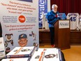 Gazette cartoonist Terry Mosher, a.k.a. Aislin, is seen at the Atwater Library in April, surrounded by copied of his new book and jerseys of former Expos players behind him.