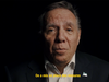 Screenshot of François Legault in front of a black background with the subtitle "on a mis en place des mesures"
