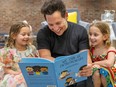 Shopify president Harley Finkelstein reads his book to his daughters Zoe, 5, left, and Bayley, 7, at the book's launch at the company's offices in Montreal on Tuesday
