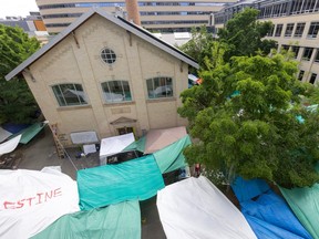 An aerial image shows tents outside a building, including one very close to the entrance