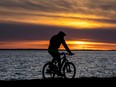 A cyclist rides along the lakeshore in Lachine.
