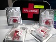 A naloxone kit with nasal spray packages