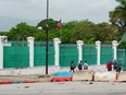 People walk by the National Palace in Port-au-Prince, Haiti, on April 26, 2024.
