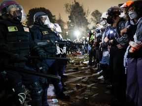 Police face off with pro-Palestinian students after destroying part of the encampment barricade on the campus of the University of California, Los Angeles (UCLA) in Los Angeles, California, early on May 2, 2024.