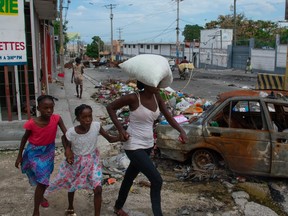 People flee their neighborhoods after after armed gangs terrorized the Delmas 24 and Solino areas on the night of May 1, in Port-au-Prince, Haiti, May 2 ,2024.