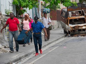 People flee their neighborhoods after after armed gangs terrorized the Delmas 24 and Solino areas on the night of May 1, in Port-au-Prince, Haiti, May 2, 2024.