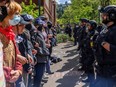 Pro-Palestinian students and activists face police officers after protesters were evicted from the library on campus earlier in the day at Portland State University in Portland, Oregon on May 2, 2024.