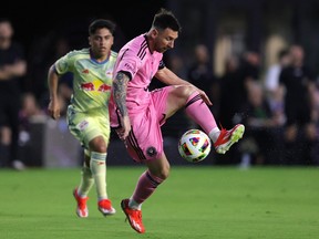 Lionel Messi kicks a ball in midair above his knee
