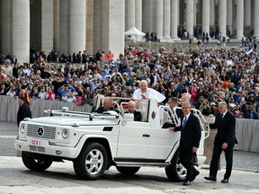 Pope Francis greets the crowd from the popemobile during the weekly general audience on May 8, 2024 at St Peter's square in The Vatican.