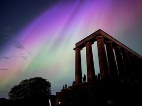 This handout photo taken and released by Jacob Anderson shows the northern lights, or aurora borealis, during a solar storm over the National Monument of Scotland in Edinburgh on Friday, May 10, 2024.