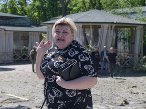 A local resident reacts near the damaged building housing the Paradise restaurant following a strike in Donetsk, Russian-controlled Ukraine, on Saturday, May 11, 2024, amid continuing Russian-Ukrainian conflict.