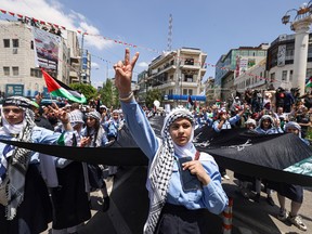 Palestinian protesters take to the streets of the West Bank city of Ramallah on May 15, 2024 to mark the 76th anniversary of the "Nakba" or "Catastrophe."