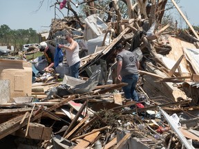 Residents continue recovery and cleanup efforts with the help of family and friends following Tuesday's destructive tornado on May 23, 2024, in Greenfield, Iowa.