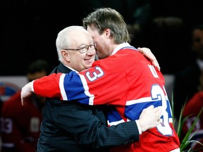 Former Canadiens goalie Patrick Roy, right, embraces his former head coach Jacques Demers during his retirement ceremony at the Bell Centre.