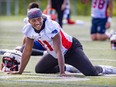 A smiling Kaion Julien-Grant is seen stretching during Alouettes training camp practice in St-Jérôme.