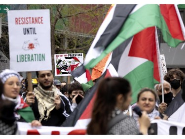 People slowly march through the streets of Montreal to the pro-Palestinian encampment at McGill University in Montreal on Saturday, May 4, 2024.