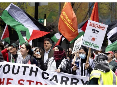 People slowly march through the streets of Montreal to the pro-Palestine encampment on McGill University's lower field in Montreal on Saturday, May 4, 2024.