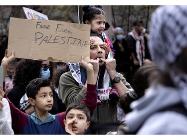 A family takes part in a march to the pro-Palestinian encampment on McGill University's lower field in Montreal on Saturday, May 4, 2024.