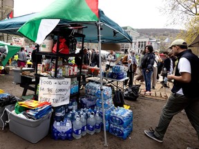 A community food and water station is seen at the campground on the lower field of McGill University in Montreal on Saturday, May 4, 2024.