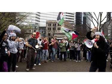 A man leads the crowd through a song during a pro-Palestine demonstration that ended at the encampment on McGill University's lower field, in Montreal on Saturday, May 4, 2024.