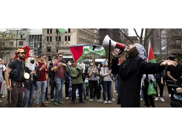 A man leads the crowd to sing during a pro-Palestinian demonstration that ended at the encampment on McGill University's lower field, in Montreal on Saturday, May 4, 2024.