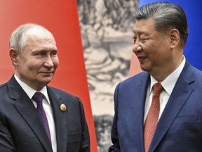 Chinese President Xi Jinping, right, and Russian President Vladimir Putin look toward each other as they shake hands prior to their talks in Beijing, China, on Thursday, May 16, 2024.