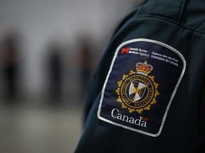 A patch is seen on the shoulder of a Canada Border Services Agency officer's uniform