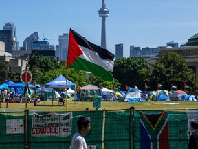A Palestinian flag flies over the pro-Palestinian encampment set up at the University of Toronto campus in Toronto on Sunday, May 26, 2024.