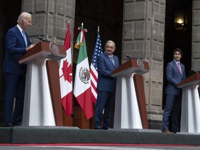 United States President Joe Biden and Prime Minister Justin Trudeau listen to Mexican President Andres Manuel Lopez Obrador speak during a joint news conference as they take their seats for a meeting at the at the North American Leaders Summit, in Mexico City, Tuesday, Jan. 10, 2023.