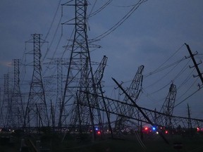 Transmission power lines are down near the Grand Parkway and West Road after a storm May 16, 2024, in Cypress, Texas.