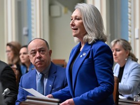 Quebec Minister for Health and for Seniors Sonia Belanger tables a legislation on end of life care and assisted death, Thursday, February 16, 2023 at the legislature in Quebec City. Quebec Health Minister Christian Dube, left, looks on.