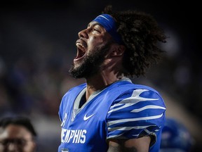 Geoffrey Cantin-Arku, seen in the blue Memphis jersey, shouts for joy after creating a turnover.