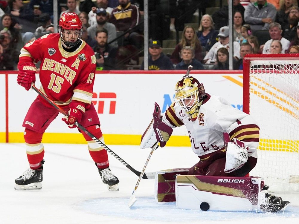 Boston College goaltender Jacob Fowler blocks a shot as Denver forward Carter King closes in during championship game of the Frozen Four NCAA tournament last month in St. Paul, Minn.
