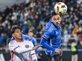 CF Montréal's Mathieu Choiniere, right, clears the ball with a header as Orlando City's Facundo Torres moves in during game in Montreal last month.