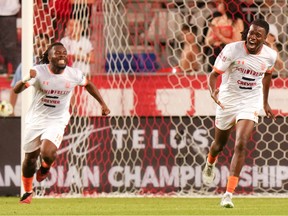 CS Saint-Laurent's Rickson Aristilde, right, celebrates scoring his team's goal against Toronto FC as he is is seen screaming with joy in front of the Toronto net with an unnamed teammate running alongside him.