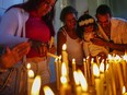 People light candles in honor of Cuba's patron saint, the Virgin of Charity of Cobre, at her shrine in El Cobre, Cuba, Feb. 11, 2024.