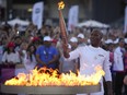 Torchbearer Didier Drogba of France holds the torch to light the cauldron at the Velodrome stadium in Marseille, southern France, Thursday, May 9, 2024.