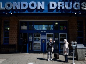 People wait outside of the London Drugs Kerrisdale location on Monday, April. 29, 2024.