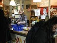 Store manager Zachary Weingarten helps members cash out at the Karma Co-op Food Store in Toronto, Friday, March 15, 2024.