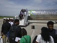 Passengers wait to board a World Atlantic plane at the Toussaint Louverture International Airport in Port-au-Prince, Haiti, Monday, May 20, 2024.