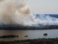 A wildfire burns in northern Manitoba near Flin Flon, as seen from a helicopter surveying the situation, Tuesday, May 14, 2024.