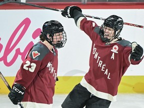 Montreal defender Erin Ambrose, who led all players in scoring last month, has been named one of the Professional Women's Hockey League's top stars of April. Ambrose (23) celebrates with teammate Laura Stacey after scoring against Toronto during second-period PWHL hockey action at the Bell Centre in Montreal, Saturday, April 20, 2024.