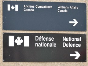 Signs for a National Defence and Veterans affairs office is pictured in St-Jean-sur-Richelieu on Monday, Oct. 20, 2014.