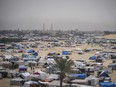 Palestinians displaced by the Israeli air and ground offensive on the Gaza Strip walk through a makeshift tent camp in Rafah, Gaza, Friday, May 10, 2024.