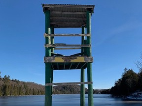 A lifeguard tower overlooking a lake with low mountains surrounding it