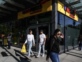 Customers leave a new "small format" No Frills grocery store, which the company is testing, in Toronto, Thursday, May 30, 2024.