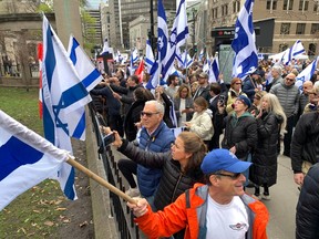 People wave Israeli flags outside McGill University