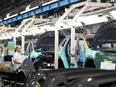Honda employees work along the vehicle assembly line in Alliston, Ont., on Thursday, April 25, 2024.