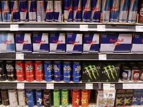 Rows of energy drink cans fill the shelves of a grocery store.